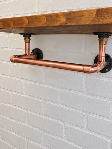 Copper clothes rail with - clothes,
